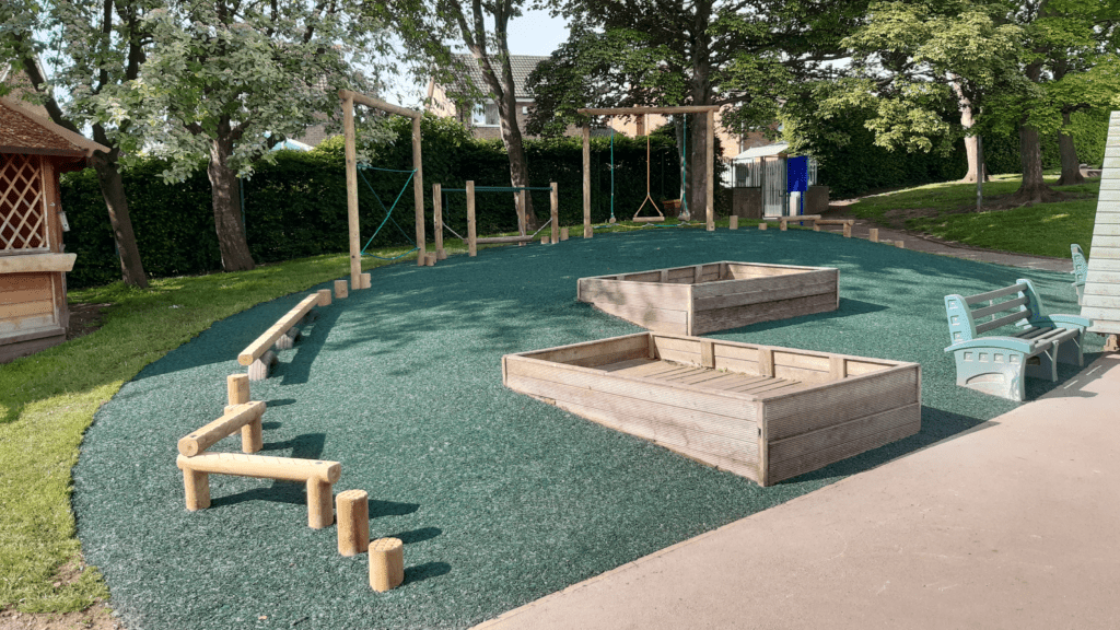 Trim trail school playground equipment installed in green epoxy rubber bonded bark
