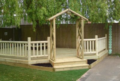 School decking area with trellis arch and planter