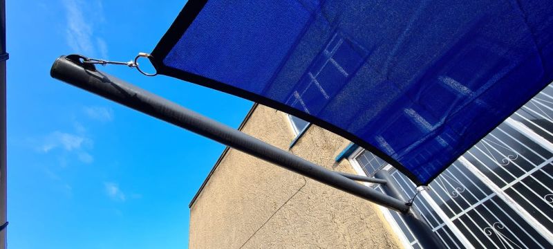 Blue rectangular shade sail installed for a school
