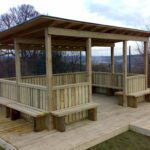 Timber Meadow Outdoor Classroom with boarded felt roof, timber fencing, and built-in seating for schools.