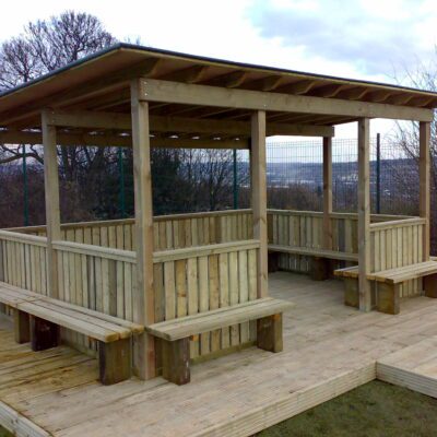 Timber Meadow Outdoor Classroom with boarded felt roof, timber fencing, and built-in seating for schools.