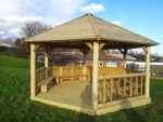 Classic Timber Roof Gazebo for schools with shiplap cladding, boarded roof, decking floor, and seating for up to 35 children.