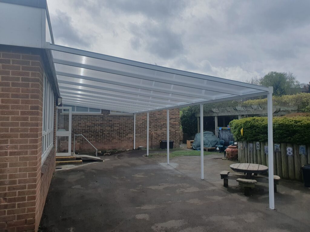 Polycarbonate school canopy in Rotherham with clear roof panels and white aluminium frame