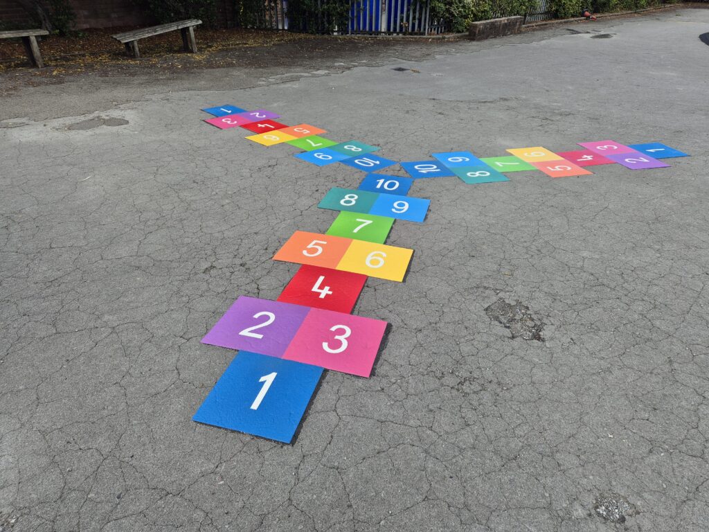Colourful three-way hopscotch playground marking installed at school play area