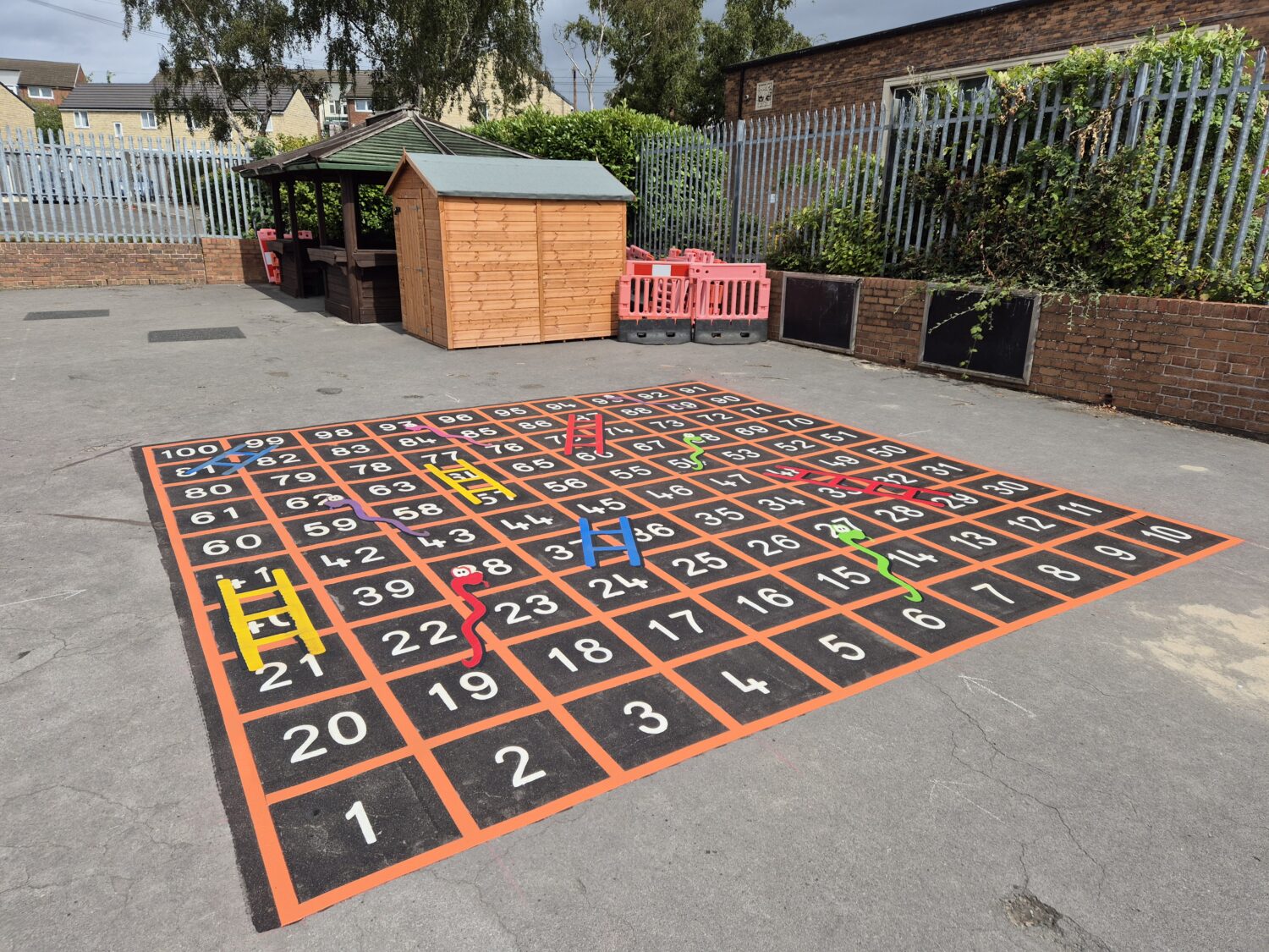 Large 1 to 100 snakes and ladders playground marking for school play area